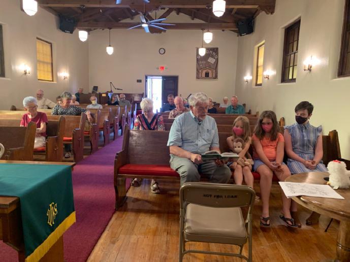 Decorative image of church congregation, taken from the pulpit at the front of the church and looking back.